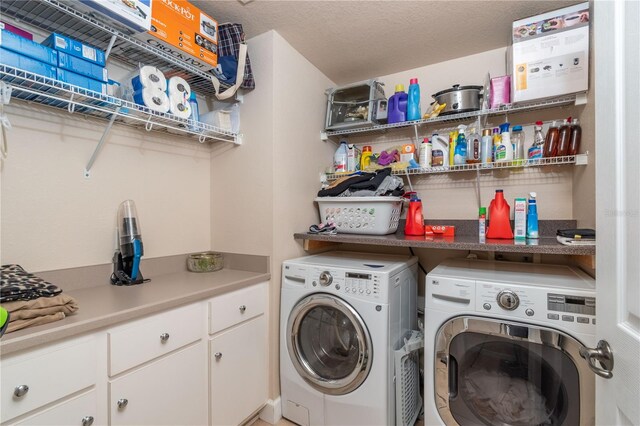 clothes washing area featuring separate washer and dryer and a textured ceiling