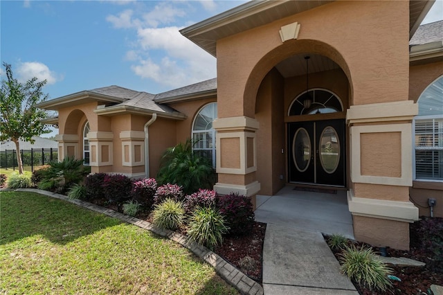 view of exterior entry with a lawn