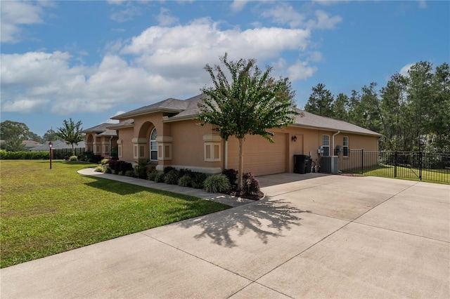 view of front of home with central air condition unit, a front yard, and a garage