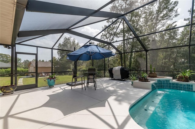 view of pool featuring pool water feature, glass enclosure, area for grilling, and a patio area