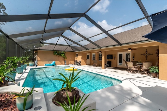 view of pool featuring french doors, a patio, ceiling fan, and a lanai