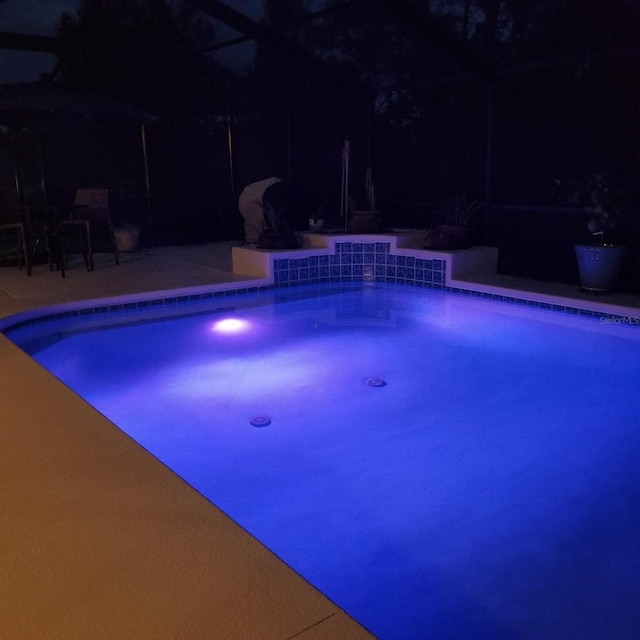 view of pool at night