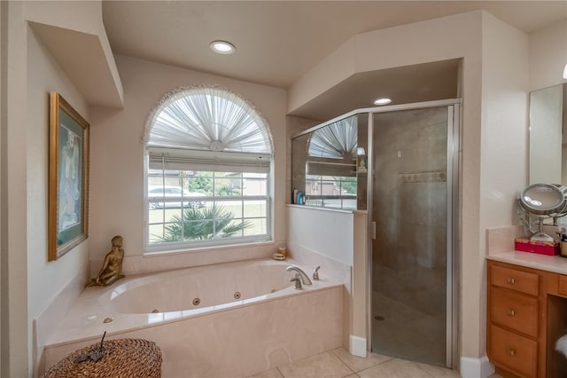 bathroom featuring tile patterned flooring, vanity, and separate shower and tub