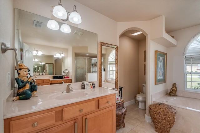 full bathroom with tile patterned floors, vanity, toilet, and independent shower and bath