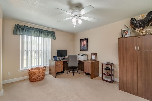 office featuring ceiling fan, light colored carpet, and a textured ceiling