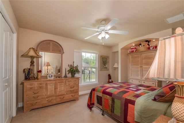 carpeted bedroom with a closet and ceiling fan