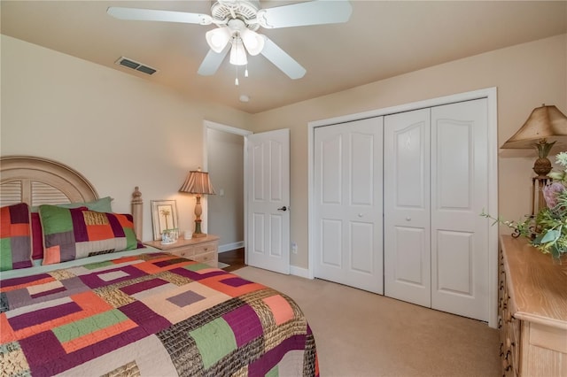 carpeted bedroom featuring a closet and ceiling fan