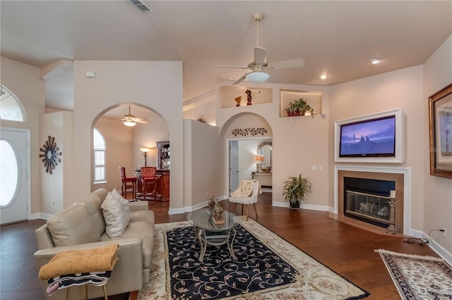 living room with ceiling fan and dark wood-type flooring