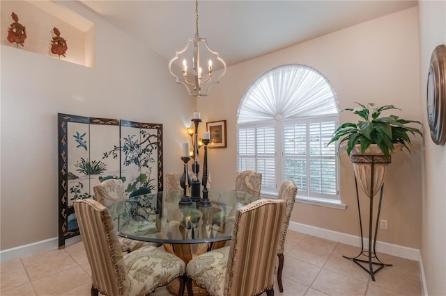 tiled dining space with a chandelier and vaulted ceiling