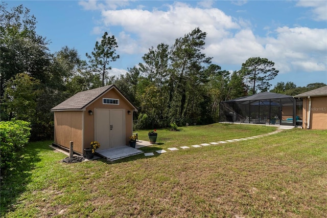 view of yard featuring a lanai, a swimming pool, and a storage unit