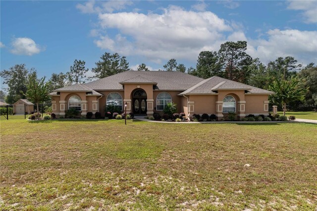 ranch-style home with a front lawn