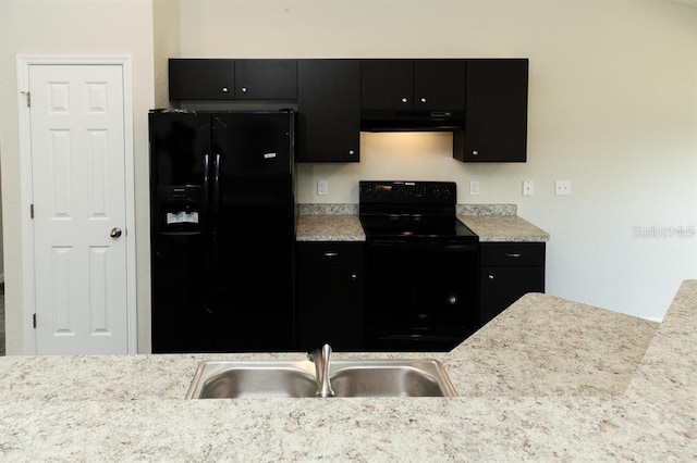 kitchen featuring range hood, black appliances, and sink