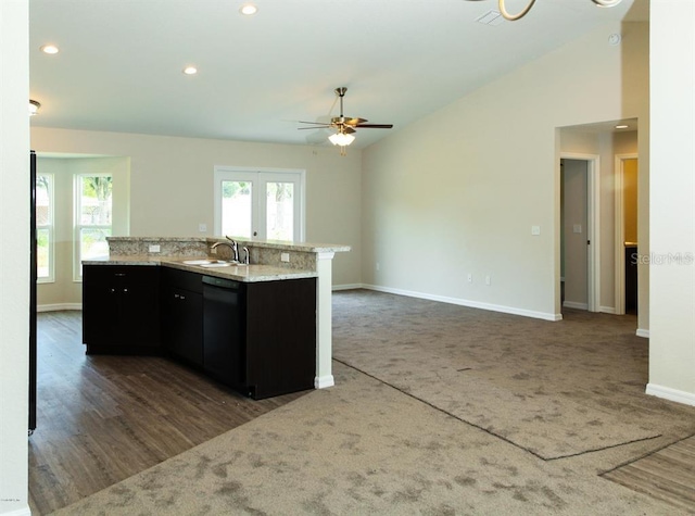 kitchen featuring an island with sink, black dishwasher, ceiling fan, lofted ceiling, and dark hardwood / wood-style flooring