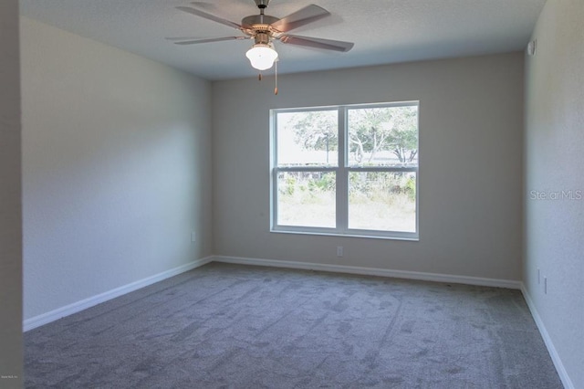 unfurnished room featuring light colored carpet, ceiling fan, and a wealth of natural light