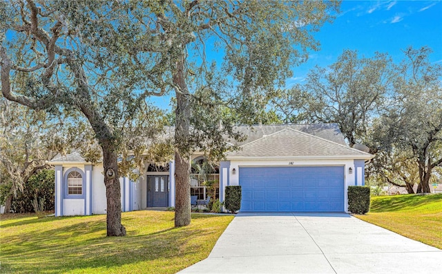 view of front facade featuring a garage and a front lawn