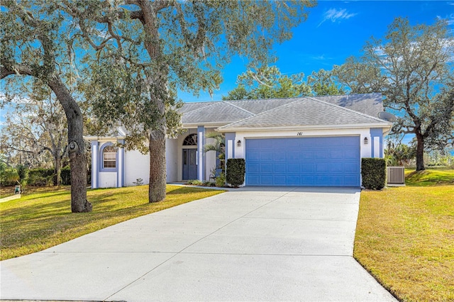 single story home featuring a garage and a front lawn