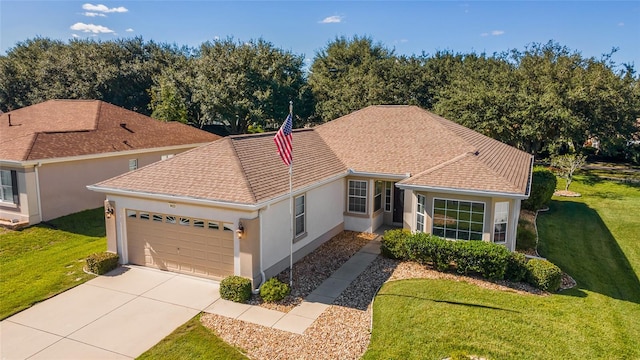 view of front of home featuring a garage and a front lawn