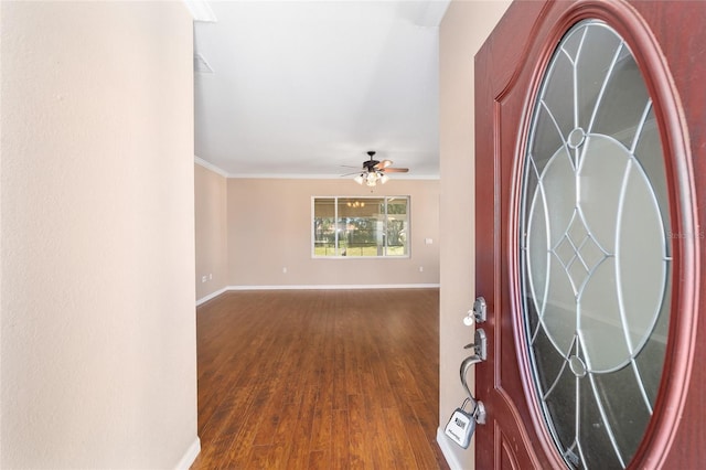 foyer entrance featuring dark hardwood / wood-style floors, ceiling fan, and crown molding