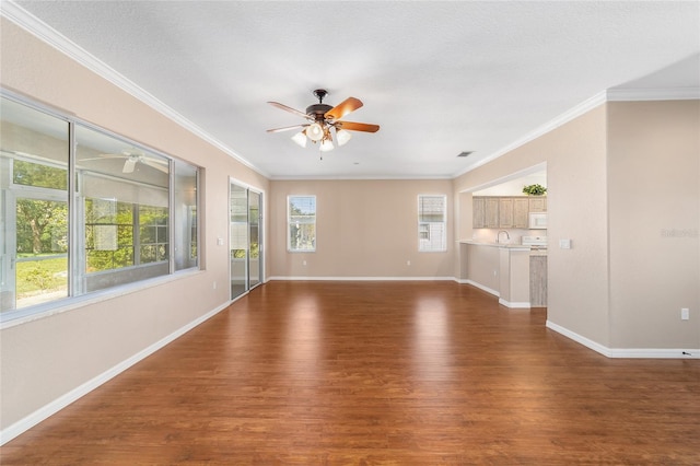 unfurnished living room featuring ornamental molding, a textured ceiling, dark wood-type flooring, and sink