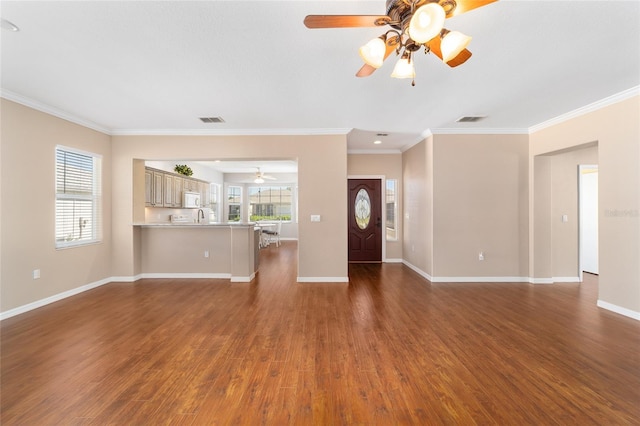 foyer with dark hardwood / wood-style floors, ceiling fan, and ornamental molding