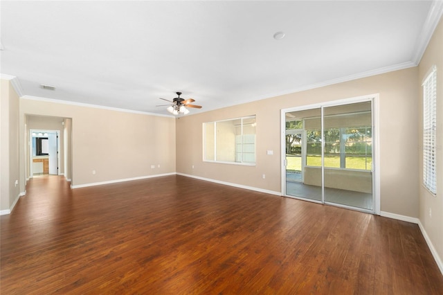 unfurnished room featuring dark wood-type flooring, crown molding, ceiling fan, and a healthy amount of sunlight