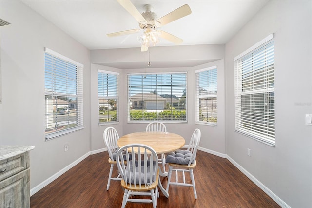 dining room featuring dark hardwood / wood-style flooring, ceiling fan, and a healthy amount of sunlight