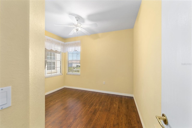 unfurnished room featuring ceiling fan and dark wood-type flooring