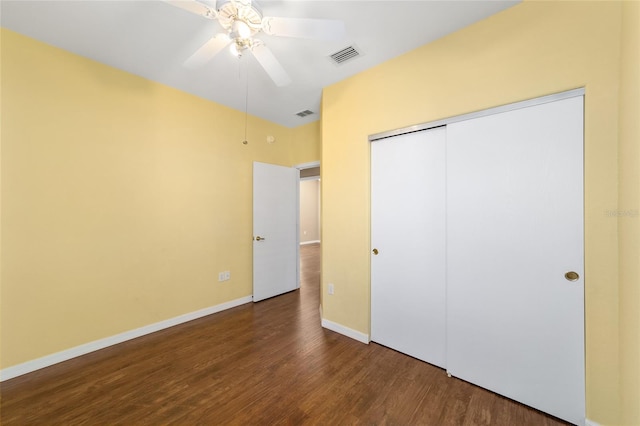 unfurnished bedroom featuring hardwood / wood-style floors, a closet, and ceiling fan