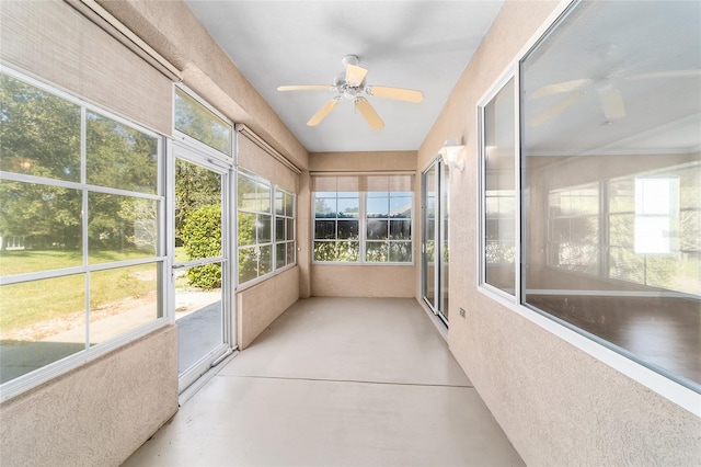 unfurnished sunroom with plenty of natural light and ceiling fan