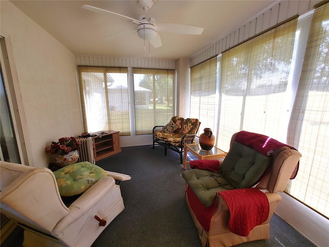 sunroom / solarium featuring ceiling fan