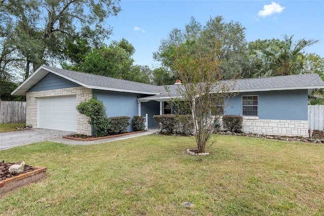 ranch-style home with a front lawn and a garage