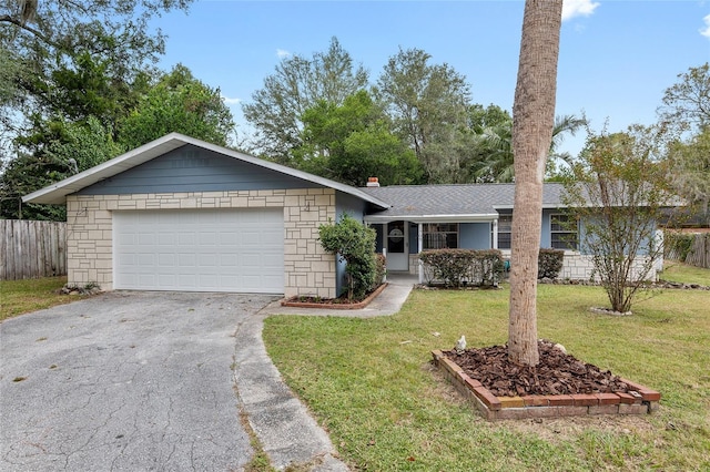 single story home featuring a front lawn and a garage