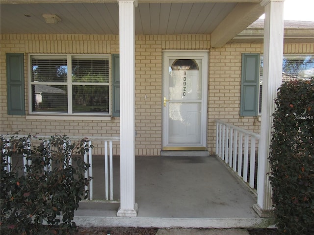 view of exterior entry with covered porch