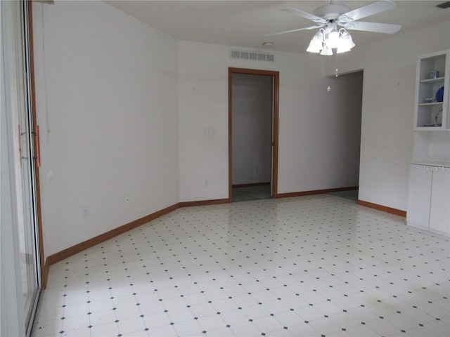 unfurnished room featuring ceiling fan and light tile flooring