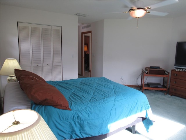 bedroom with ceiling fan, carpet floors, and a closet