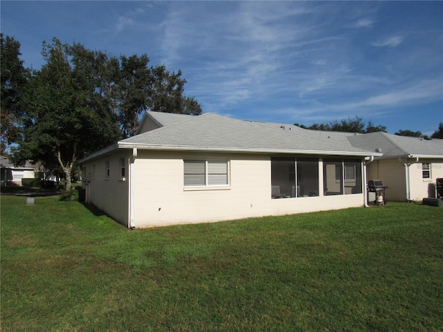 back of house with a lawn