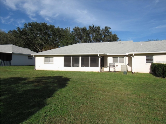 back of property featuring a yard