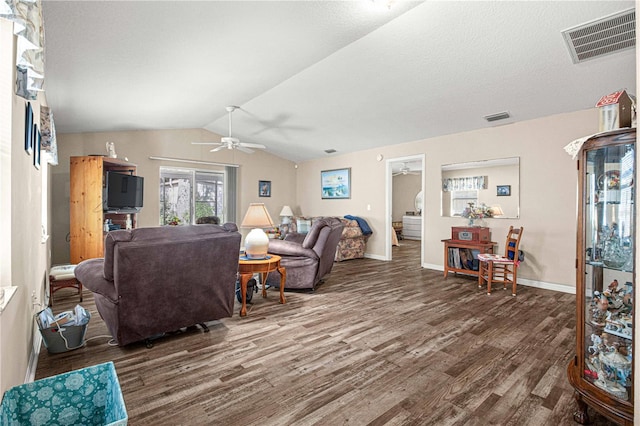 living room with ceiling fan, dark wood-type flooring, and vaulted ceiling