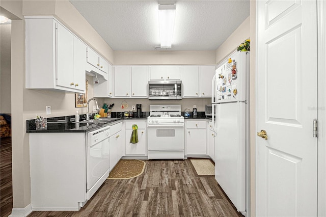 kitchen featuring white cabinetry, white appliances, sink, and dark hardwood / wood-style flooring