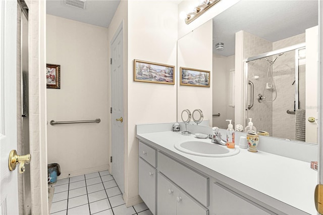 bathroom featuring a shower with door, tile floors, and large vanity