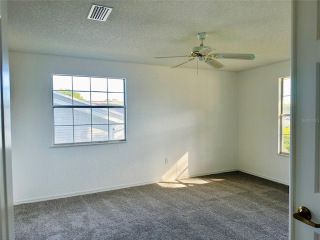 spare room with ceiling fan, carpet flooring, and a textured ceiling