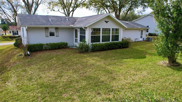 back of property with a yard and cooling unit