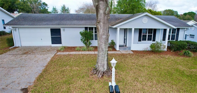 single story home featuring a front yard, covered porch, and a garage