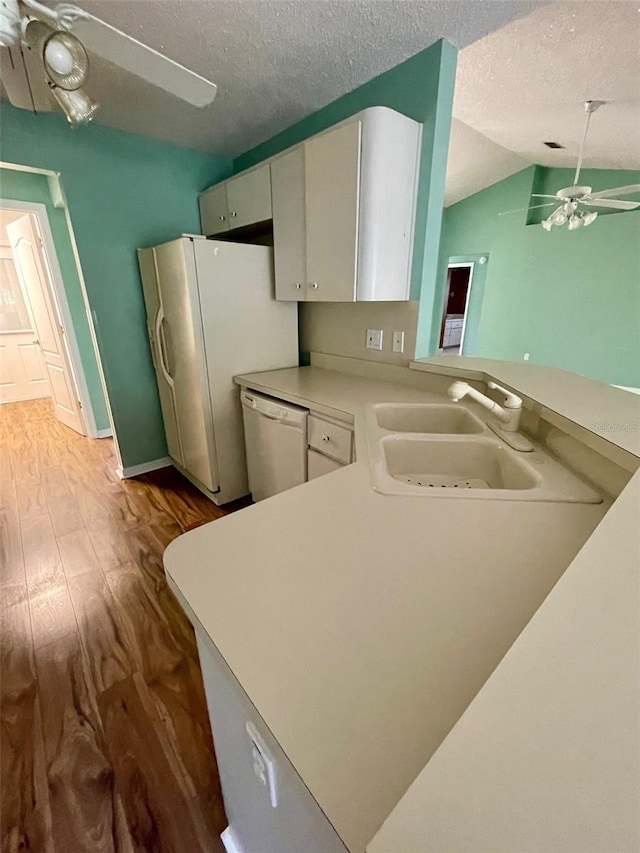 kitchen featuring ceiling fan, dishwashing machine, light hardwood / wood-style floors, and white cabinets