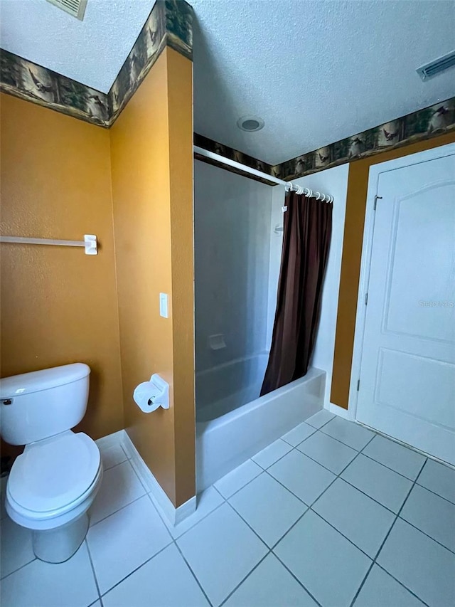 bathroom with shower / tub combo, a textured ceiling, toilet, and tile floors