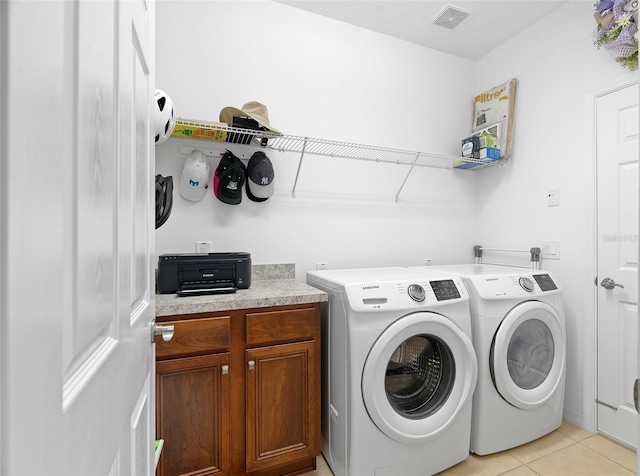 3554 NW 55th Cir, Ocala, FL 34482 - clothes washing area with separate washer and dryer, light tile patterned flooring, and cabinet space