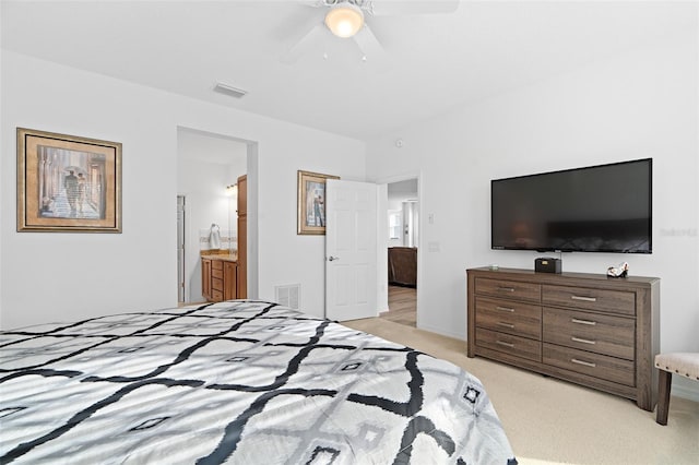 3554 NW 55th Cir, Ocala, FL 34482 - bedroom featuring light colored carpet, a ceiling fan, and ensuite bathroom