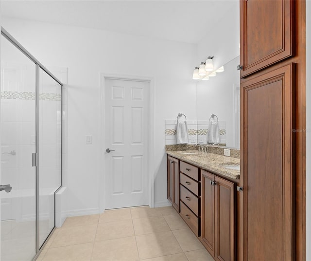 3554 NW 55th Cir, Ocala, FL 34482 - full bathroom featuring tile patterned flooring, double vanity, a shower stall, and baseboards
