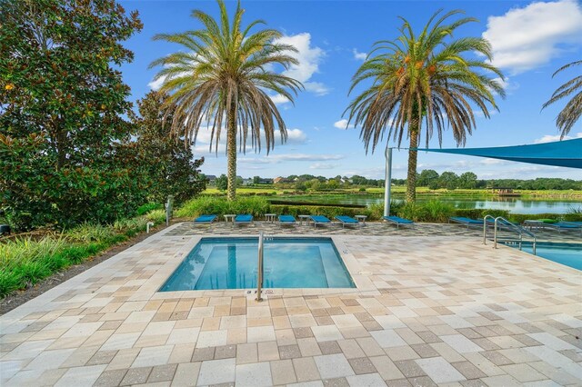 3554 NW 55th Cir, Ocala, FL 34482 - swimming pool with a patio area and a water view