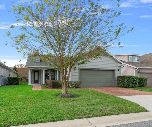 3554 NW 55th Cir, Ocala, FL 34482 - view of front of home with decorative driveway, a garage, and a front yard